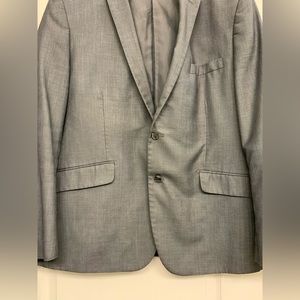 Men’s grey suit comes with pants.